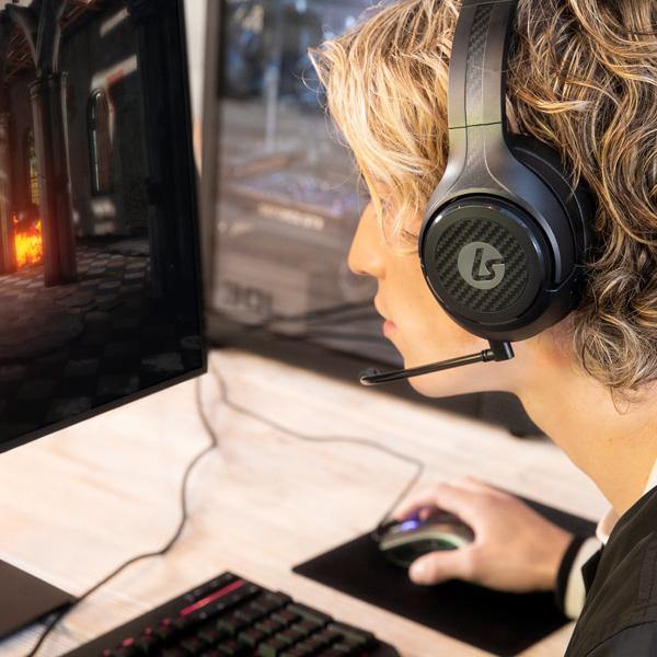 Player wearing LucidSound Shock Blue headphones playing with a shock blue xbox series x|s controller